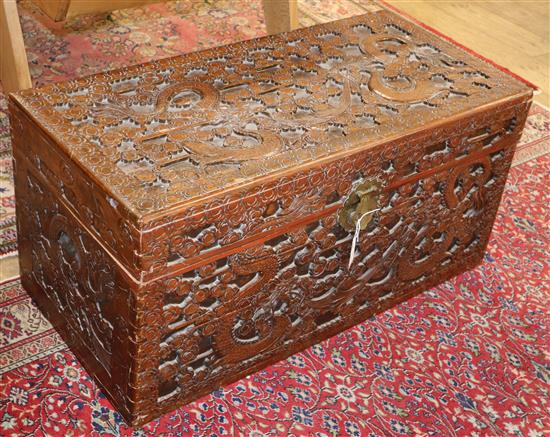 A Cantonese camphor wood chest, carved with dragons and stylised clouds W.101cm